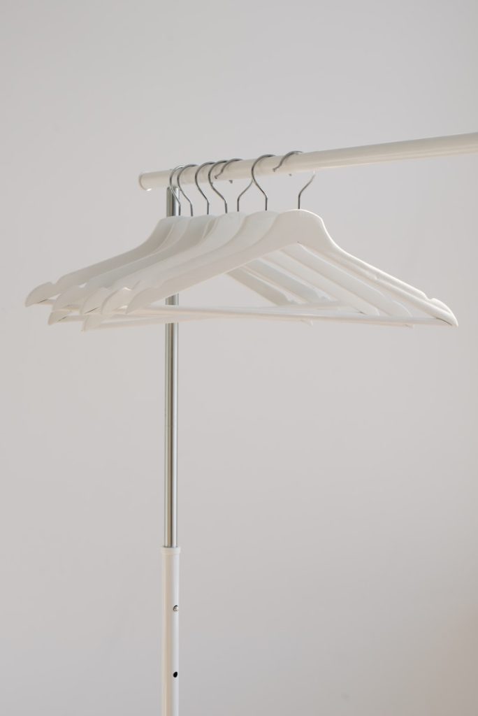 Photo by Andrej Lišakov white clothes hangers hanging on rack